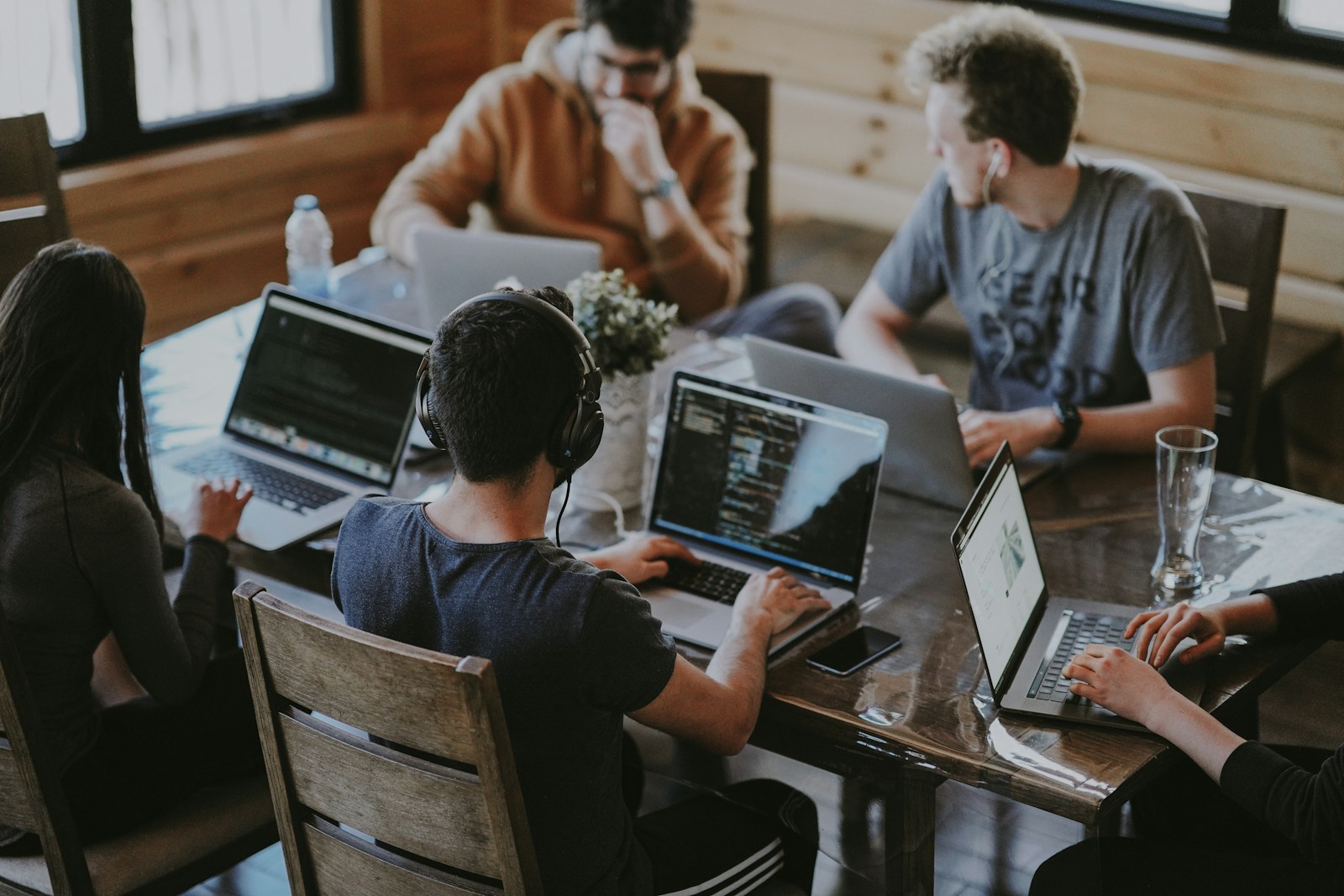 People exchanging ideas around a shared workspace, an illustrative collaboration photograph